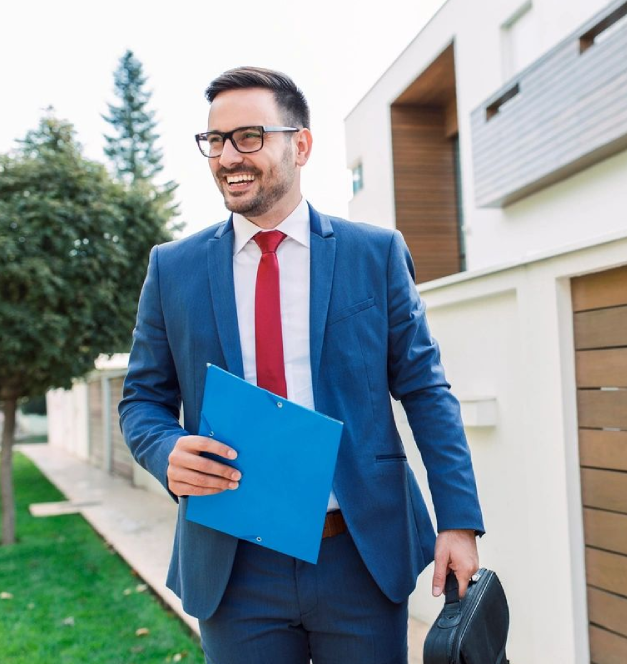 sdgggf A man in a suit and tie holding a blue folder.