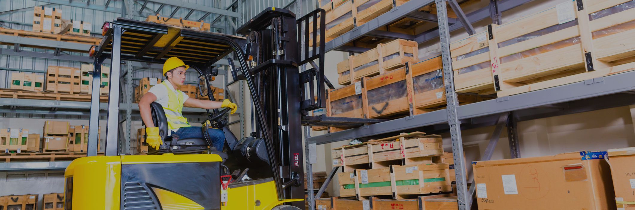 GettyImages-2187549183.jpg-v1 A forklift is moving boxes in an industrial warehouse.